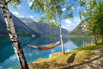 colorful empty hammock on a mountain lake