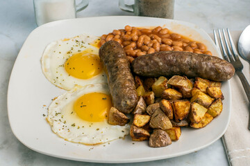two ried eggs top with parsley  with  sweet italian sauage