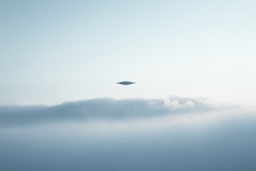 Fototapeta premium UFO floating above misty clouds........