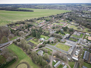 Aerial view of horse racing stables and therapy buildings seen nestled between large private houses...