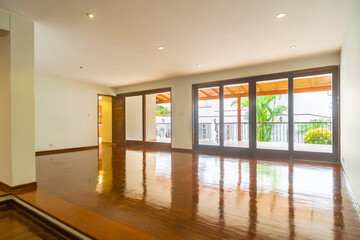 sala de departamento con amplia ventana con vista externa, piso de melamina parquet e iluminada