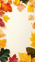 Colorful autumn leaves arranged on a neutral background create a vibrant seasonal display perfect for fall-themed decor and art projects