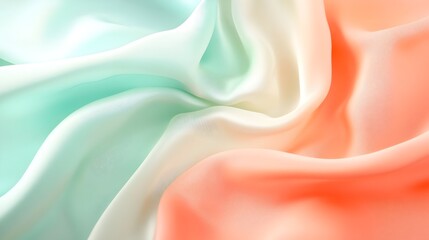 a close-up of soft, flowing fabric draped in a gradient of vibrant colors reminiscent of the Indian flag: mint green, white, and peachy orange. The fabric's gentle folds and smooth texture create 