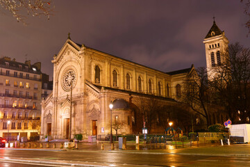 Fototapeta premium Church of Notre Dame des Champs at rainy night. It is a Roman Catholic church located at Boulevard du Montparnasse in Paris. France.