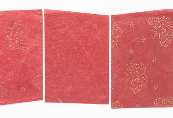 bright red paper with fiber texture and gold glitter pattern on white