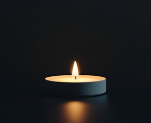 A single candle flame glowing in the darkness isolated on black background, minimalism, stock photo 