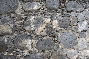 Close Up of Stone Wall with Random Shaped Grey Stones  