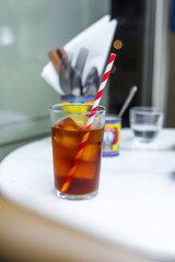 Iced Tea in Glass with Red and White Straw – Refreshing Paris Café Drink