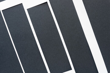 white stencil with rectangular stripes or bands machine-cut from white paper and arranged on black 
