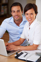 Laptop, business and portrait of couple in office with support, notes and collaboration at financial consultancy. Man, woman and team partnership at advisory agency with planning in budget management