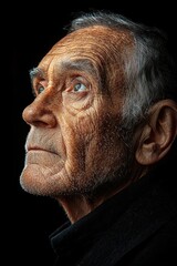 Obraz premium A weathered elderly mans profile gazing upward