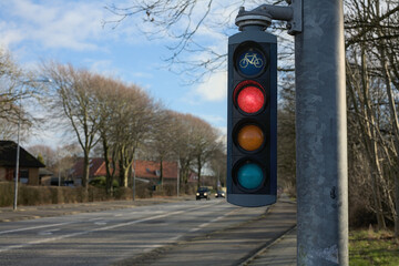 Traffic light signals for cyclists on a peaceful suburban street during a clear day