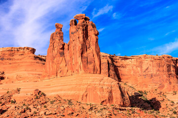 Fototapeta premium A large rock formation with two smaller rocks on top of it