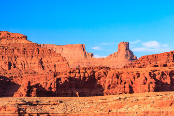 A desert landscape with a large mountain in the background
