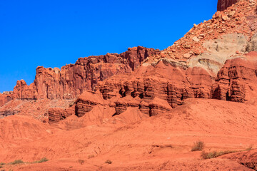 Fototapeta premium A rocky, red hillside with a blue sky in the background
