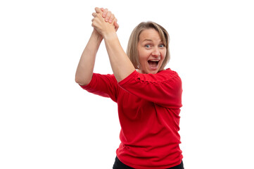 A cheerful woman in a red shirt expressing excitement with raised hands against a white background.