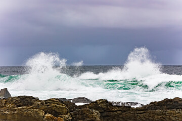 Large Indian Ocean waves and rocky coastline in Tsitsikamma, Garden Route National Park, Eastern Cape. South Africa