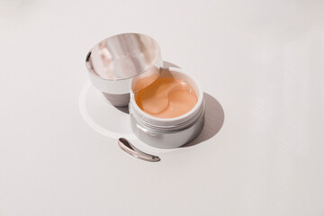 Hydrogel eye patches оn a light background. Bathroom treatments. Homemade face care.