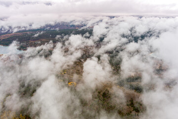 Aerial view of clouds over a forest landscape