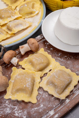 Italian food, fresh home made stuffed pasta ravioli dumplings with ricotta soft cheese and champignons porcini mushrooms, Parma, Emilia Romagna, Italy