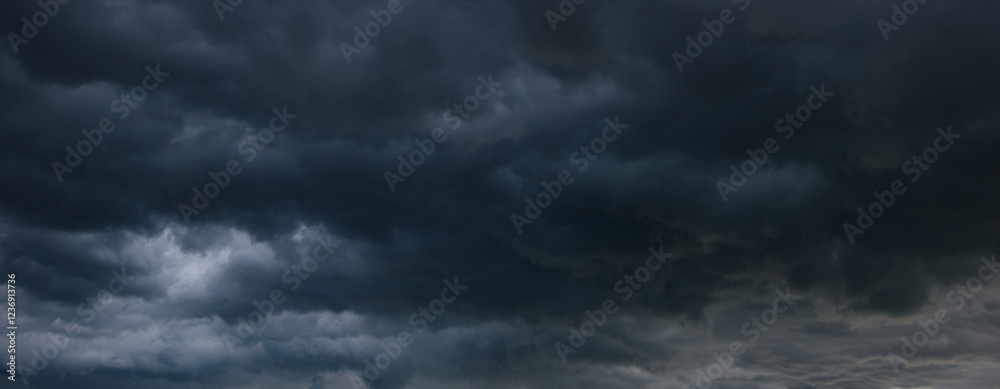 Poster a stormy sky filled with dark, heavy clouds signals an impending windstorm, creating a dramatic and 