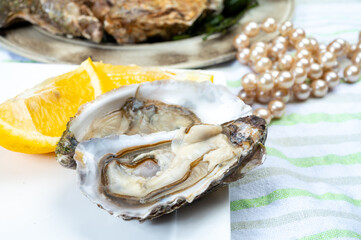 Plate with fresh live raw Fine de Claire Oleron oysters seashells served oyster-farming village, Marennes Oleron area, France