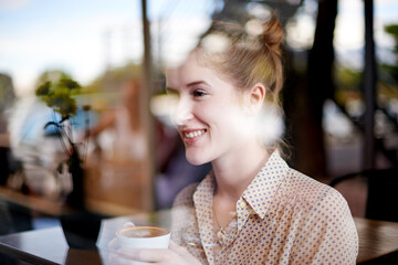 Coffee, happy and woman by cafe window for thought in morning with creative digital nomad career. Planning, thinking and freelance copywriter drink cappuccino with literature project at restaurant.