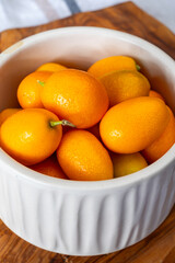 Delicious small citrus fruits orange kumquats close up