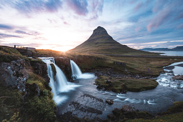 Breathtaking Kirkjufell mountain and Kirkjufellsfoss waterfall on the Snaefellsnes Peninsula, Iceland, near Grundarfjordur, with a stunning sunset backdrop