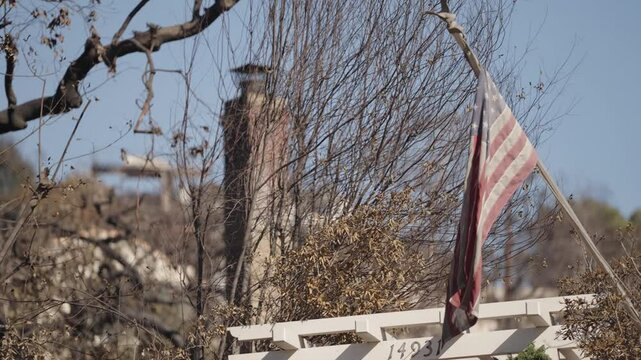 Burnt flag flying in the air after the palisades wild fires
