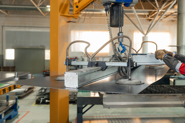 Male worker use Vacuum transporter operating industrial machinery in manufacturing facility