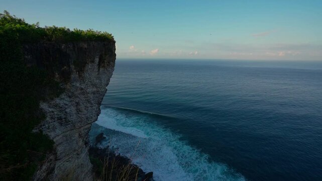 Karang Boma Cliff Bali on background ocean waves crashing on the tropical beach Bali Indonesia 4K