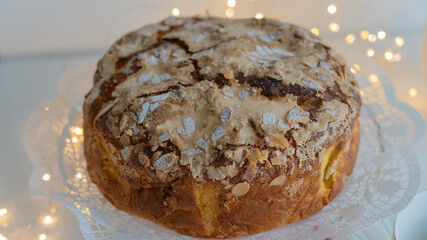 Panettone with a light decorations, Christmas cake on the table