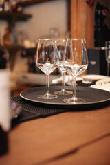 Two empty, beautiful, clean glasses are on a tray in the restaurant.