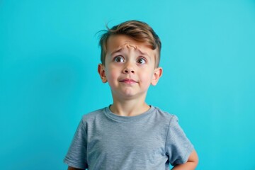 Boy is looking up at something with surprised look on his face