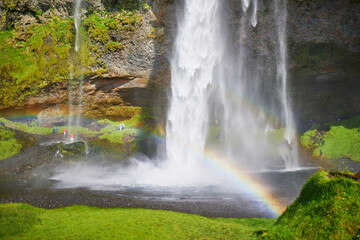 Scenic view of Seljalandsfoss with rainbow, one of the biggest waterfalls of Iceland, with rainbow.