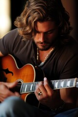 Obraz premium Get Out Your Guitar Day Guitarist in a tranquil moment playing acoustic guitar