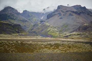 Scenic view of black volcanic mountains and Vatnajokull (Vatna glacier) in Iceland.