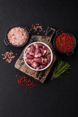 Raw chicken hearts with salt, spices and herbs
