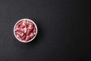 Raw chicken hearts with salt, spices and herbs