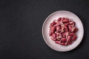 Raw chicken hearts with salt, spices and herbs