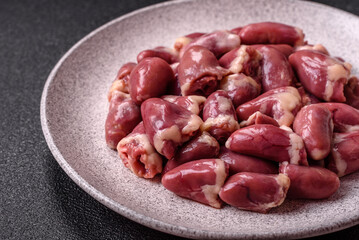 Raw chicken hearts with salt, spices and herbs