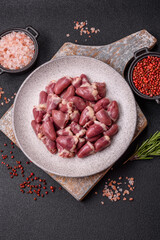 Raw chicken hearts with salt, spices and herbs