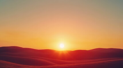 Obraz premium Wide-angle view of a sunset over rolling hills with vibrant orange hues, serene tones