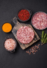 Fresh raw ground beef or pork burger patty with salt and spices