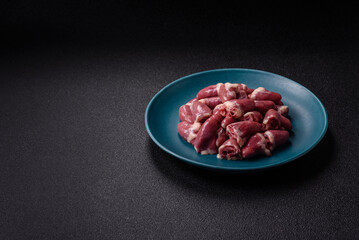 Raw chicken hearts with salt, spices and herbs