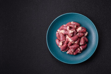 Raw chicken hearts with salt, spices and herbs