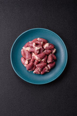 Raw chicken hearts with salt, spices and herbs