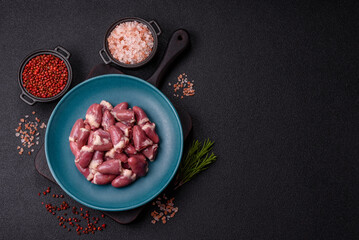 Raw chicken hearts with salt, spices and herbs