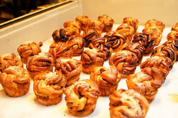 Assortment of different types of braided bread, Babka on display of a cake shop